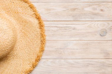 Summer holidays. Summer concept with straw hat and tropical leaf. Flat lay, top view, copy space.