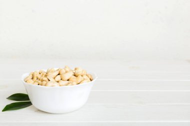 cashew nuts in wooden bowl on table background. top view. Space for text. Healthy food