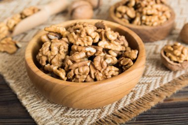 Fresh healthy walnuts in bowl on colored table background. Top view Healthy eating bertholletia concept. Super foods.