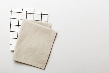 top view with gray kitchen napkin isolated on table background. Folded cloth for mockup with copy space, Flat lay. Minimal style.