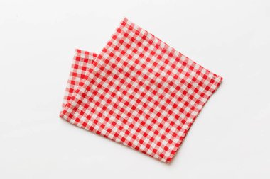 top view with red empty kitchen napkin isolated on table background. Folded cloth for mockup with copy space, Flat lay. Minimal style.