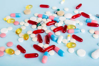 Many different colorful medication and pills perspective view. Set of many pills on colored background.
