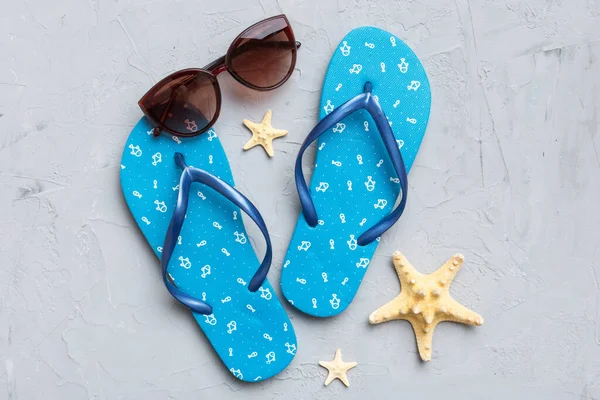 stock image Summer travel concept. Flip flops, sunglasses and starfish on white. Top view on colored background.