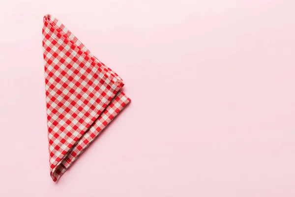 stock image top view with red empty kitchen napkin isolated on table background. Folded cloth for mockup with copy space, Flat lay. Minimal style.