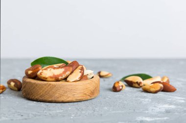 Fresh healthy Brazil nuts in bowl on colored table background. Top view Healthy eating bertholletia concept. Super foods.
