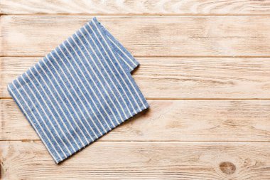 top view with blue kitchen napkin isolated on table background. Folded cloth for mockup with copy space, Flat lay. Minimal style.