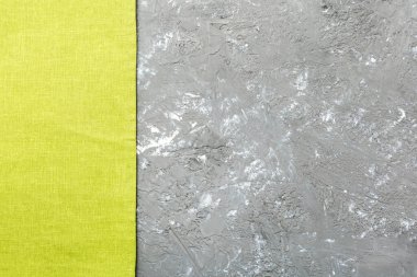 top view with green kitchen napkin isolated on table background. Folded cloth for mockup with copy space, Flat lay. Minimal style.