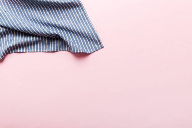 top view with blue kitchen napkin isolated on table background. Folded cloth for mockup with copy space, Flat lay. Minimal style.