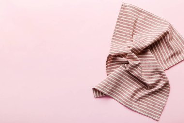 top view with red empty kitchen napkin isolated on table background. Folded cloth for mockup with copy space, Flat lay. Minimal style.
