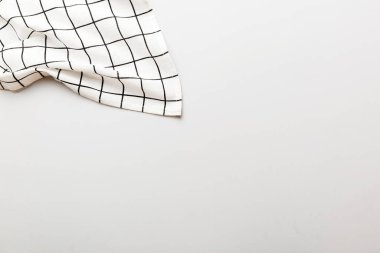 top view with white empty kitchen napkin isolated on table background. Folded cloth for mockup with copy space, Flat lay. Minimal style.