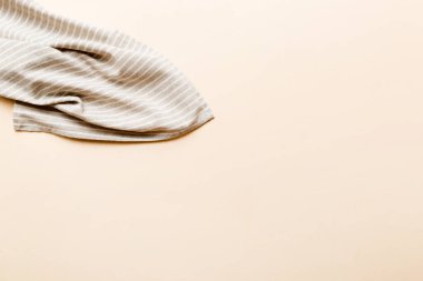 top view with gray kitchen napkin isolated on table background. Folded cloth for mockup with copy space, Flat lay. Minimal style.
