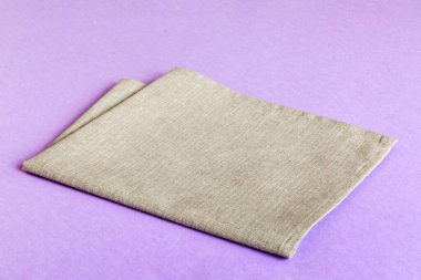top view with gray kitchen napkin isolated on table background. Folded cloth for mockup with copy space, Flat lay. Minimal style.
