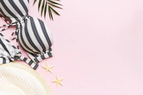 stock image Woman swimwear and beach accessories flat lay top view on colored background Summer travel concept. bikini swimsuit, straw hat and seasheels. Copy space Top view.