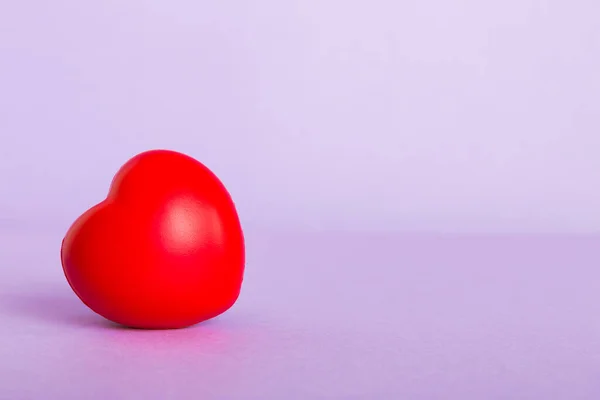 stock image gift box with red bow and red heart on colored background. Perspective view. Flat lay.