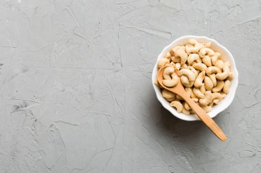 cashew nuts in wooden bowl on table background. top view. Space for text. Healthy food