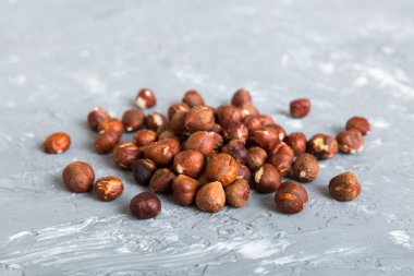 Wooden bowl full of hazelnuts on table background. Healthy eating concept. Super foods.