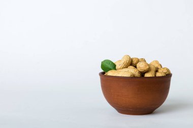 Fresh healthy peanuts in bowl on colored table background. Top view Healthy eating bertholletia concept. Super foods.
