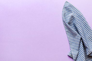 top view with blue kitchen napkin isolated on table background. Folded cloth for mockup with copy space, Flat lay. Minimal style.