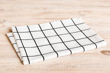 top view with white empty kitchen napkin isolated on table background. Folded cloth for mockup with copy space, Flat lay. Minimal style.