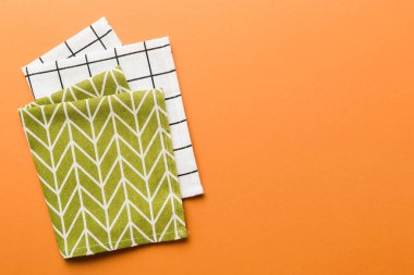 top view with green kitchen napkin isolated on table background. Folded cloth for mockup with copy space, Flat lay. Minimal style.