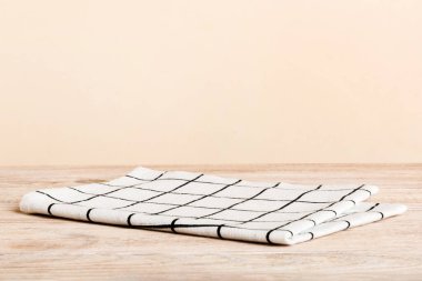 top view with white empty kitchen napkin isolated on table background. Folded cloth for mockup with copy space, Flat lay. Minimal style.