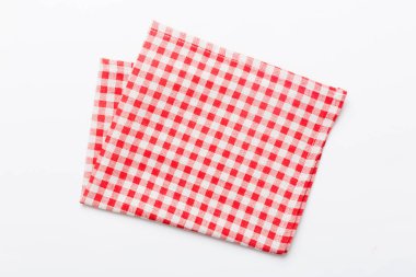 top view with red empty kitchen napkin isolated on table background. Folded cloth for mockup with copy space, Flat lay. Minimal style.