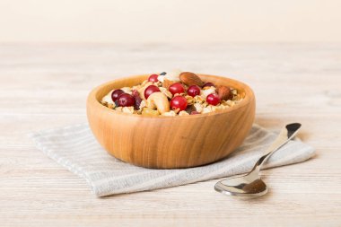 Sağlıklı bir kahvaltı hazırlıyorum. Bir kasede çeşitli kurutulmuş meyve ve fındıklı granola. Sağlıklı tatlı kavramı. Düz konum, kopyalama alanı olan üst görünüm.