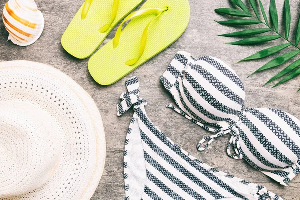 stock image Woman swimwear and beach accessories flat lay top view on colored background Summer travel concept. bikini swimsuit, straw hat and seasheels. Copy space Top view.