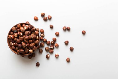 Wooden bowl full of hazelnuts on table background. Healthy eating concept. Super foods.