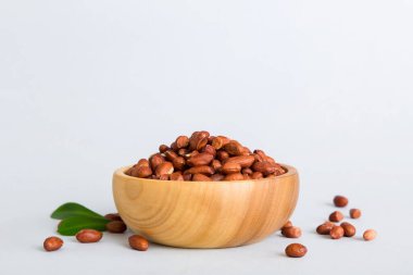 Fresh healthy peanuts in bowl on colored table background. Top view Healthy eating bertholletia concept. Super foods.