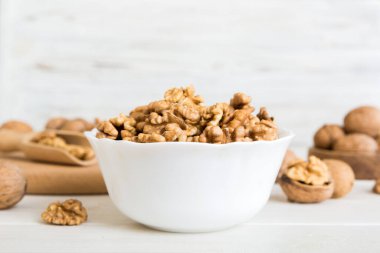 Fresh healthy walnuts in bowl on colored table background. Top view Healthy eating bertholletia concept. Super foods.