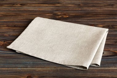 top view with gray kitchen napkin isolated on table background. Folded cloth for mockup with copy space, Flat lay. Minimal style.