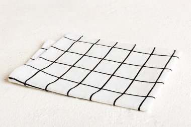 top view with white empty kitchen napkin isolated on table background. Folded cloth for mockup with copy space, Flat lay. Minimal style.