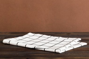 top view with white empty kitchen napkin isolated on table background. Folded cloth for mockup with copy space, Flat lay. Minimal style.