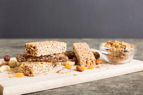 stock image Various granola bars on table background. Cereal granola bars. Superfood breakfast bars with oats, nuts and berries, close up. Superfood concept.