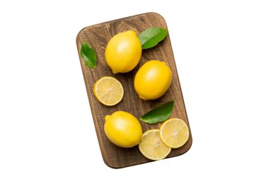 Kesme tahtasındaki taze ve olgun limonlar için fotokopi alanı olan üst manzara. Sağlıklı yemek geçmişi. Beyaz arka planda izole edilmiş limon ve limon dilimlerinin zarif arka planı.