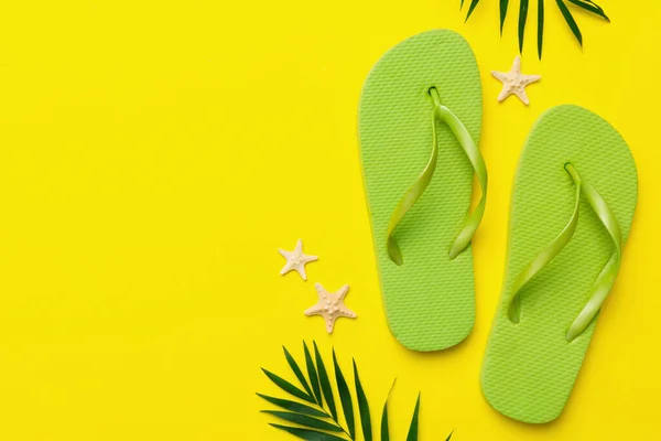 stock image Flat lay composition with flip flops and seashell on colored background. Space for text top view.