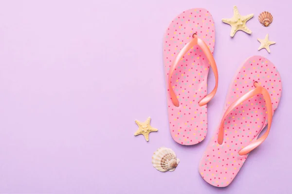 Stock image Flat lay composition with flip flops and seashell on colored background. Space for text top view.