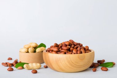 Fresh healthy peanuts in bowl on colored table background. Top view Healthy eating bertholletia concept. Super foods.