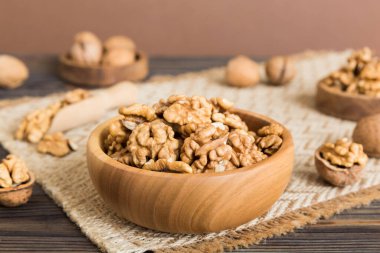 Fresh healthy walnuts in bowl on colored table background. Top view Healthy eating bertholletia concept. Super foods.