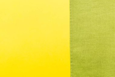 top view with green kitchen napkin isolated on table background. Folded cloth for mockup with copy space, Flat lay. Minimal style.