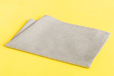 top view with gray kitchen napkin isolated on table background. Folded cloth for mockup with copy space, Flat lay. Minimal style.