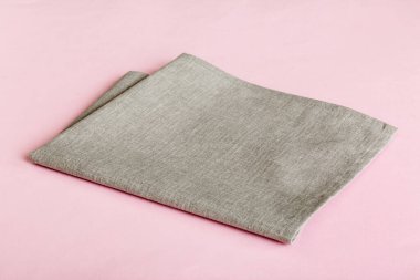 top view with gray kitchen napkin isolated on table background. Folded cloth for mockup with copy space, Flat lay. Minimal style.