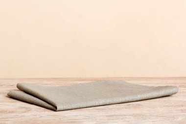 top view with gray kitchen napkin isolated on table background. Folded cloth for mockup with copy space, Flat lay. Minimal style.