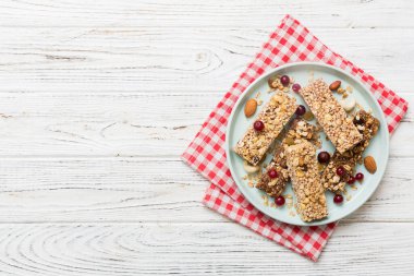 Various granola bars on table background. Cereal granola bars. Superfood breakfast bars with oats, nuts and berries, close up. Superfood concept. clipart