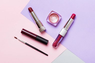 Professional makeup tools. Top view. Flat lay. Beauty, decorative cosmetics. Makeup brushes set and color eyeshadow palette on table background. Minimalistic style.