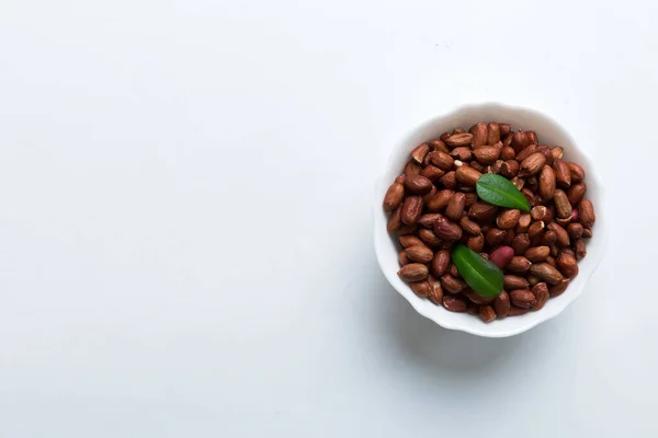 stock image Fresh healthy peanuts in bowl on colored table background. Top view Healthy eating bertholletia concept. Super foods.