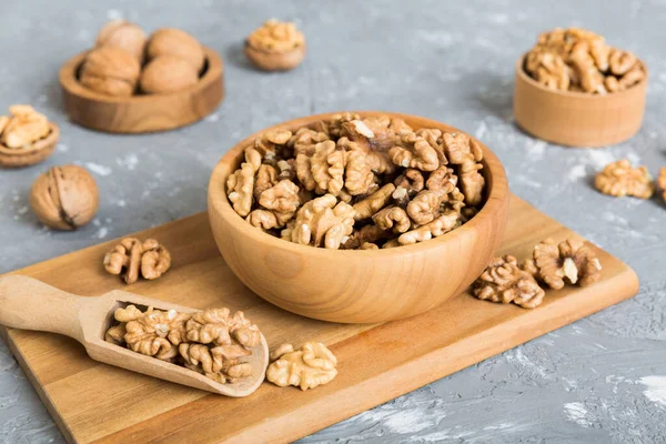 Fresh healthy walnuts in bowl on colored table background. Top view Healthy eating bertholletia concept. Super foods.