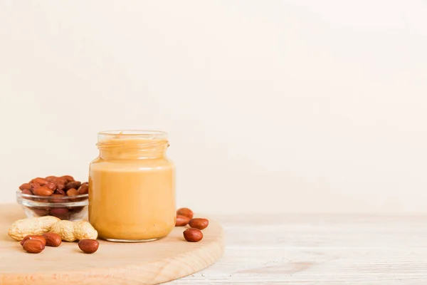 stock image Bowl of peanut butter and peanuts on table background. top view with copy space. Creamy peanut pasta in small bowl.