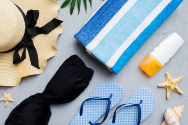Kadın mayo ve plaj aksesuarları renkli arka plan yaz seyahati konseptine düz bir görünüm kazandırıyordu. Bikini mayo, hasır şapka ve deniz topuklu ayakkabı. Üst görünümü kopyala.